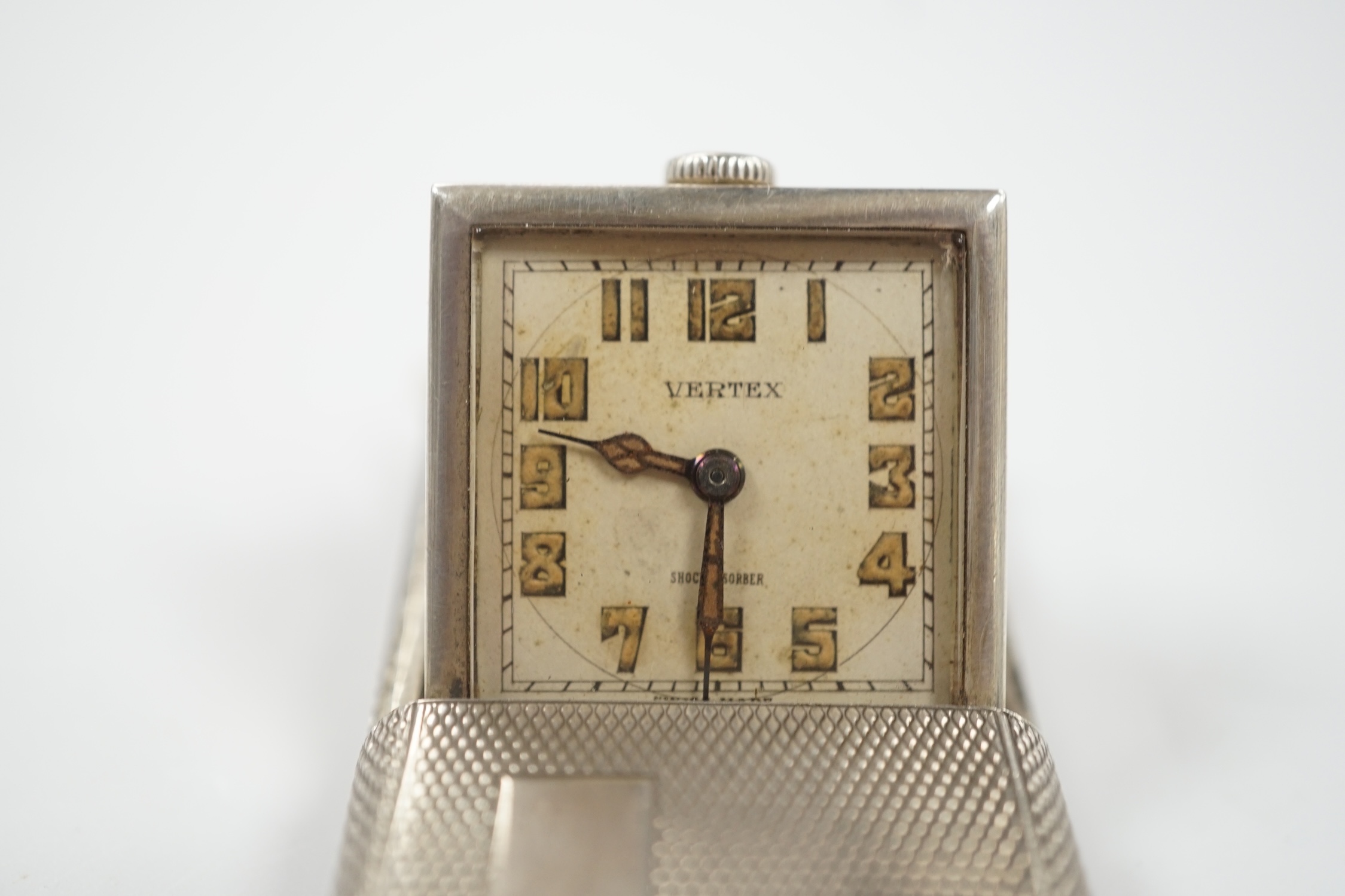 A 1920's? Swiss Vertex engine turned silver cased travelling watch, 42mm.
